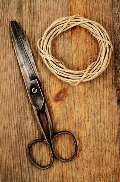 Old scissors and hank of packthread on wooden background with Grunge Filter Stock Photos