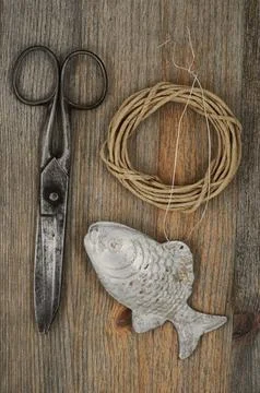 Old scissors, glasses, fish and hank of packthread over wooden background Stock Photos