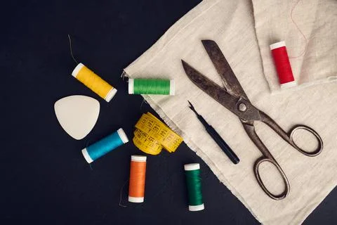 Old scissors, spools of colored thread, centimeter and tailors chalk, flat la Stock Photos