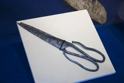 Old scissors on a white sheet of paper, closeup of photo Stock Photos
