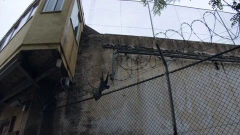 Old scraps of prisoner robe on the barbed wire of the prison. Stock Footage 165052380