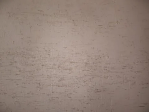 Old scratched beige wall texture with dirty abstract pattern backdrop. Stock Photos