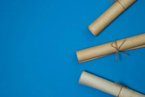 Old scrolls on a blue background. Knowledge and education concept. Stock Photos