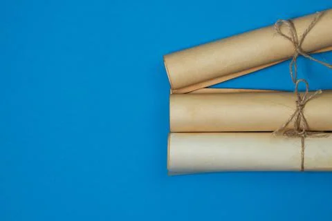 Old scrolls on a blue background. Knowledge and education concept. Stock Photos