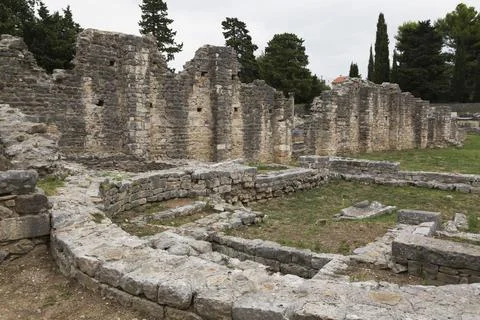 Old semi circle stone structure and walls at ancient 3rd century Roman ruins of Stock Photos