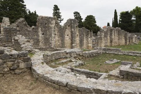 Old semi circle stone structure and walls at ancient 3rd century Roman ruins of Stock Photos