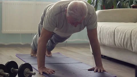 Old senior active push up from the floor on a gymnastic mat Stockbeeldmateriaal 157237769