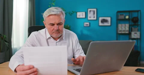 Old Senior man checking home finances and bills, he is calculating costs, using Stock Footage 149863085