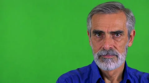 Old senior man looks to camera with serious face - green screen - studio Stock-Footage 67669929