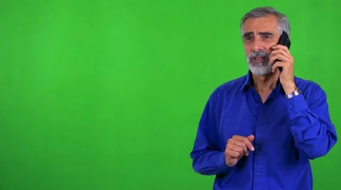 Old senior man phones with smartphone - green screen - studio Stock Footage