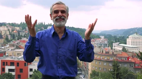 Old senior man rejoices - city (buildings) in background Stock Footage