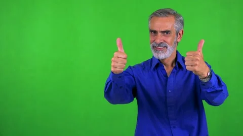 Old senior man shows thumbs up on agreement - green screen - studio Stock Footage