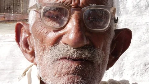 Old senior from a small village using glasses in India Stock Footage 70810116