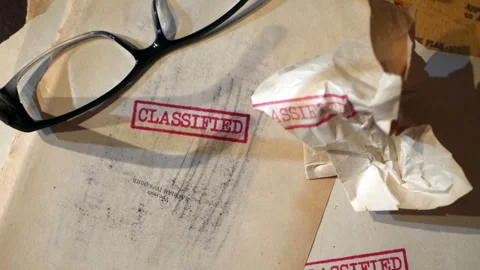 An old  sensitive documents and secret information with the stamp CLASSIFIE.. Stock Footage 320499641