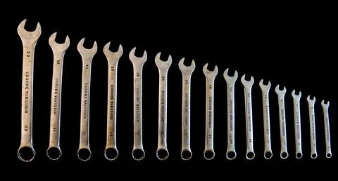 Old set of open-end wrenches isolated on black. Stock Photos