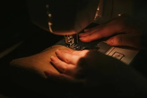 Old sewing machine with black thread scissors and needle, on a old grungy work 写真素材