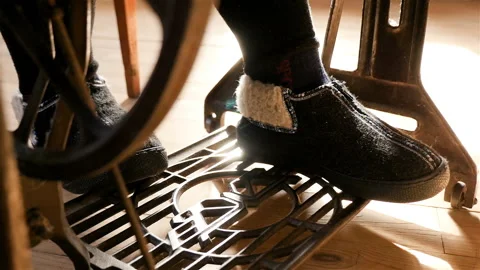 The old sewing machine. Close-up of female legs. Delayed shooting. Sewing of Stock Footage 89097771