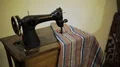 Old sewing machine with colourful canvas stitching, vintage museum exhibit HD Footage