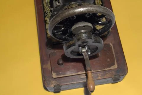 Old sewing machine rear rotating mechanism close-up. Graceful wheel and sim.. Stock Photos