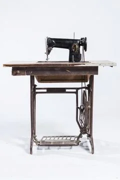 The old sewing machine on a white background Stock Photos
