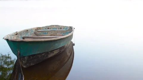 An old shabby boat without oars is moored Stock Footage 197741510