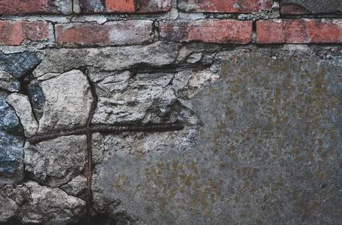 Old shade with red dirty bricks. Cracked foundation with chipped piece cement Stock Photos