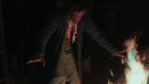 The old shaman dances around the fire Stock Footage 72596707
