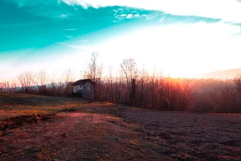 Old shed with rays of setting sun. Stock Photos