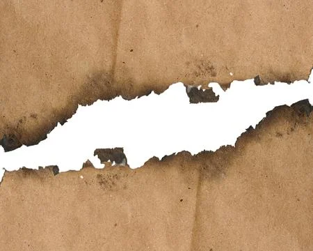 An old sheet of thick brown paper with a jagged, burnt edge and traces of s.. Stock Photos