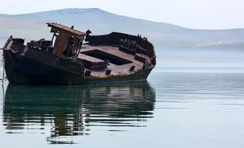 Old ship flooded on the shore of lake Baikal Stock Photos