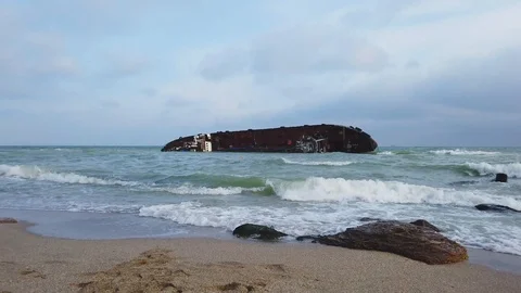 The old ship ran aground on the shore, crashed, left the ship off the coast Stock Footage 120544832