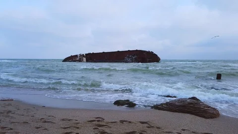 The old ship ran aground on the shore, crashed, left the ship off the coast Stock Footage 120544836