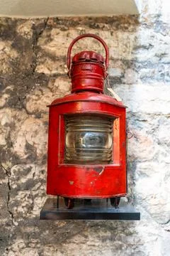 Old ship red lantern hanging on the wall. Stock Photos