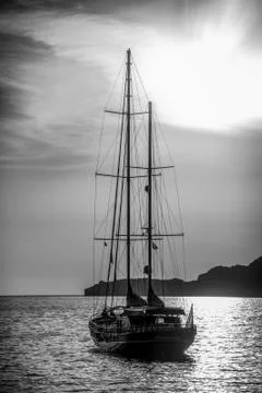 Old ship sailing to the sunset. Stock Photos