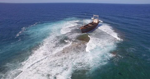 Old shipwreck in hi waves Stock Footage 90526043