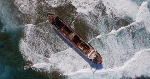 Old shipwreck in hi waves Stock Footage 90526097