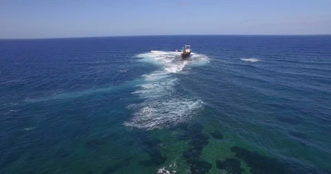 Old shipwreck in hi waves Stock Footage 90538202