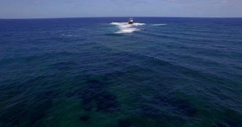 Old shipwreck in hi waves Stock Footage 90749180