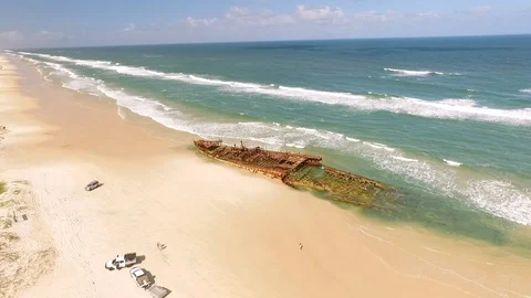 An old shipwreck is seen washed up on a beach of Fraser Island, off the coast of 库存影片 129443496