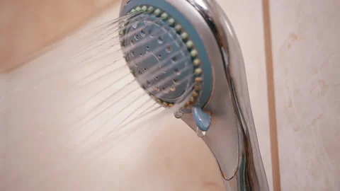 Old Shower Head with a Powerful Stream of Water Droplets Falling. Water Pressure Stock Footage 142099475