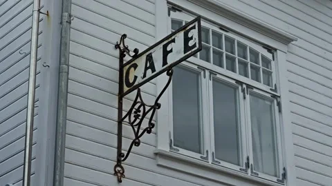 Old sign that says cafe outside a white building Stock Footage 271402927