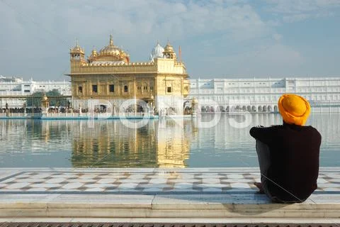 Old sikh meditating inside religious landmark of punjab - golden temple,India Stock Photos