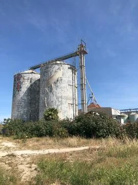 Old silos granary elevator on agro-processing manufacturing plant Stock Photos
