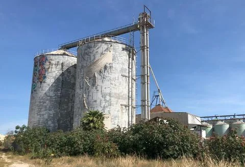 Old silos granary elevator on agro-processing manufacturing plant Stock Photos