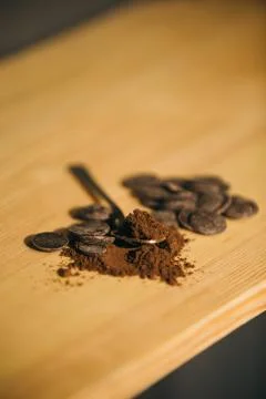 An old silver spoon with ground coffee and chocolate. Stock Photos