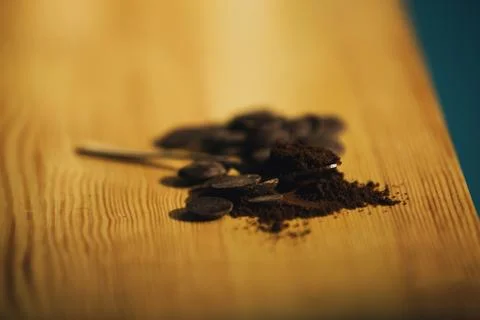 An old silver spoon with ground coffee and chocolate. Stock Photos