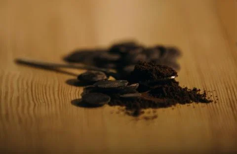 An old silver spoon with ground coffee and chocolate. Stock Photos
