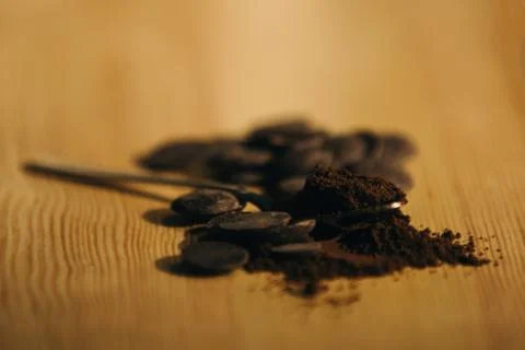 An old silver spoon with ground coffee and chocolate. Stock Photos