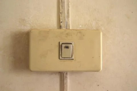Old Single white light switch on wall,old Single Electrical on off switch tha Stock Photos