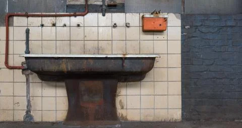 The old sink in front of the tiled wall Stock Photos